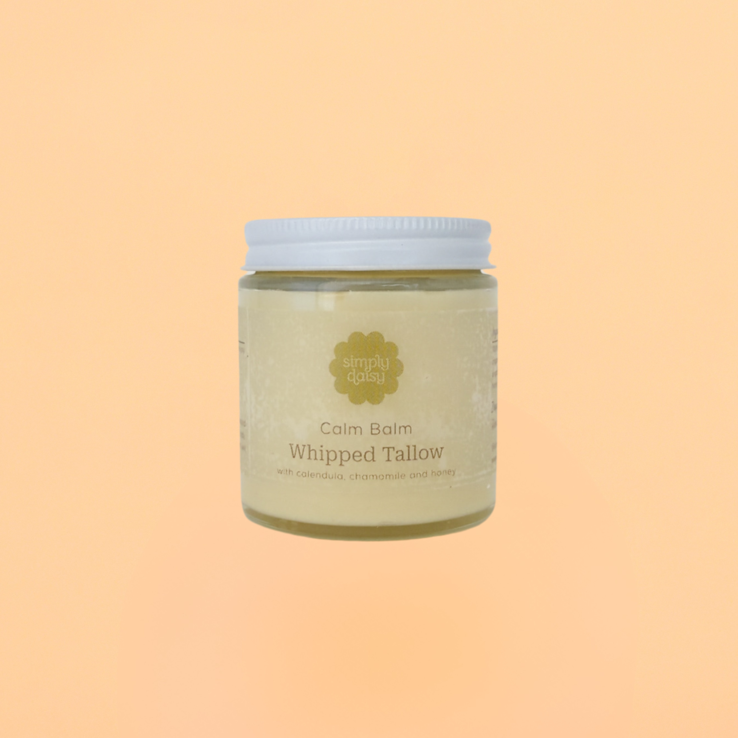 A glass jar of Calm Balm Whipped Tallow with a white label, containing a yellowish product, displayed against an orange background.