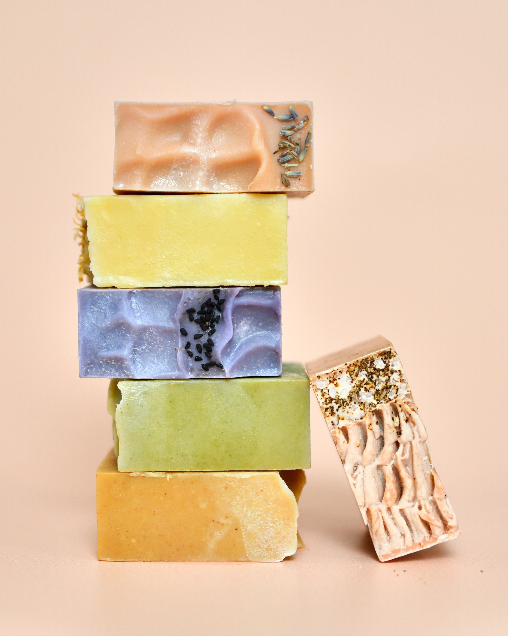 Stack of colorful soap bars on a beige background
