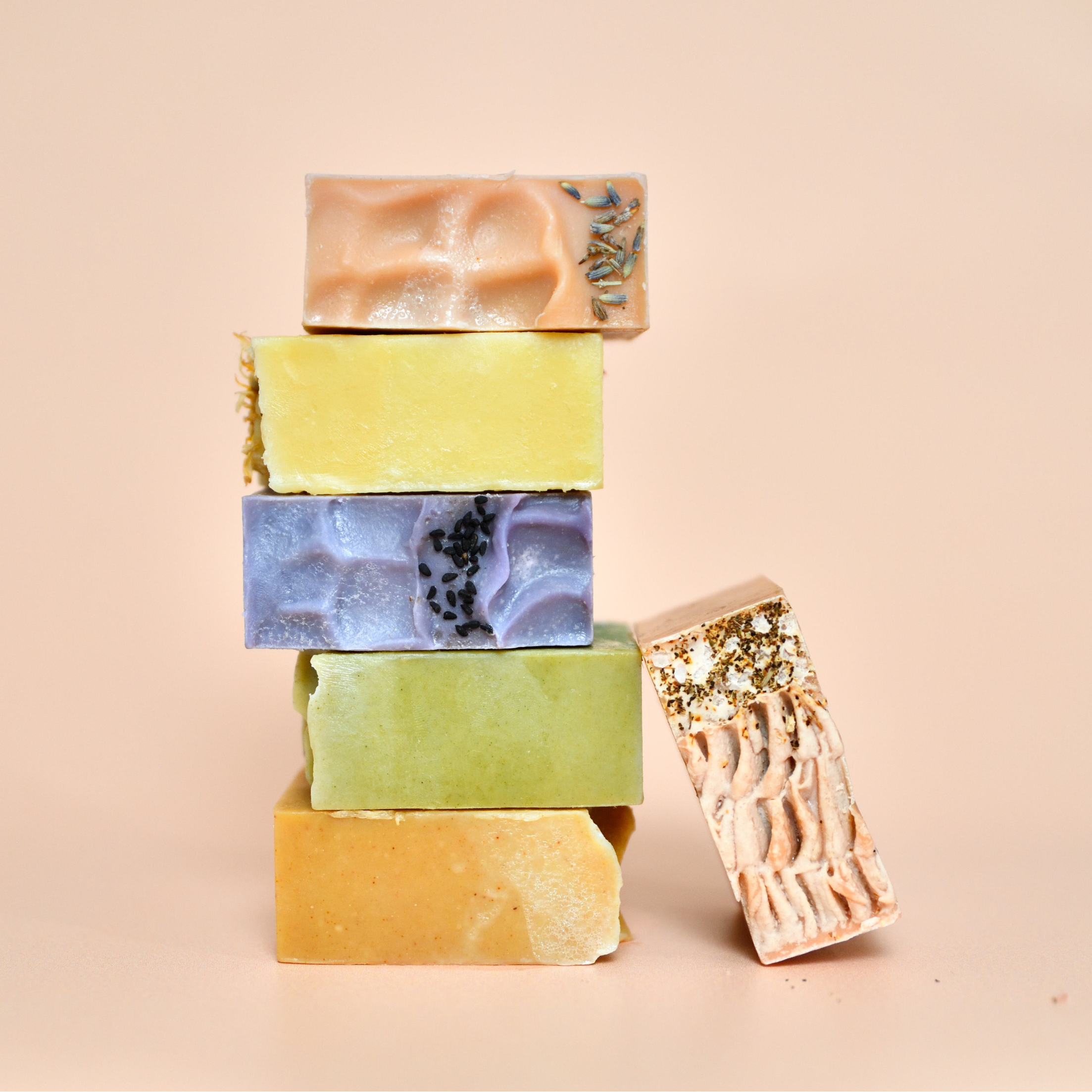 Stack of colorful soap bars on a beige background
